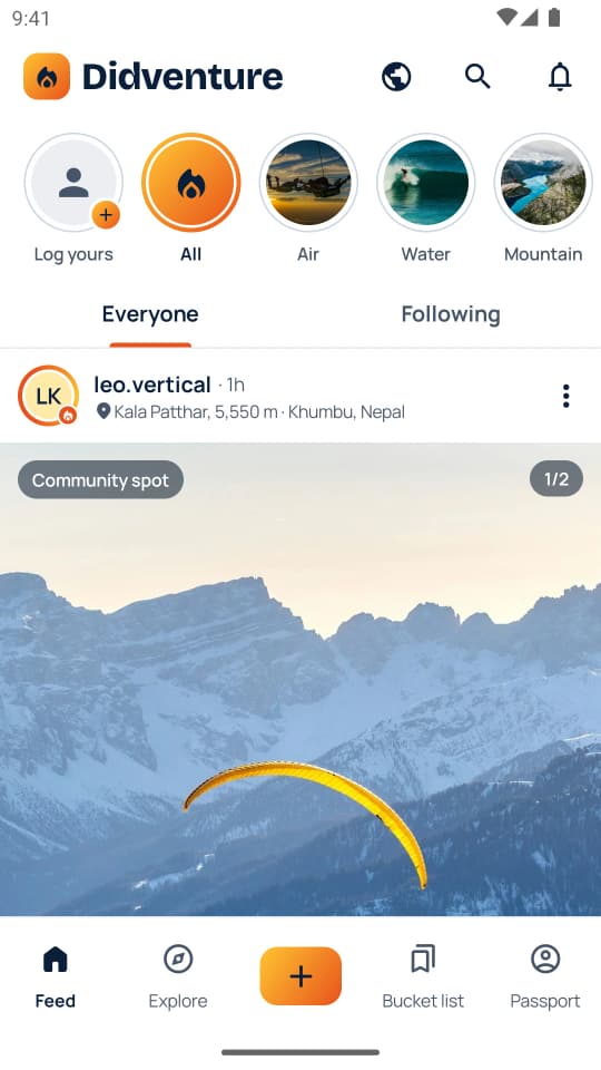 The Feed on the Everyone tab: category circles at the top and an adventure card with a photo of a paraglider over snowy mountains, marked Community spot. Sample content.